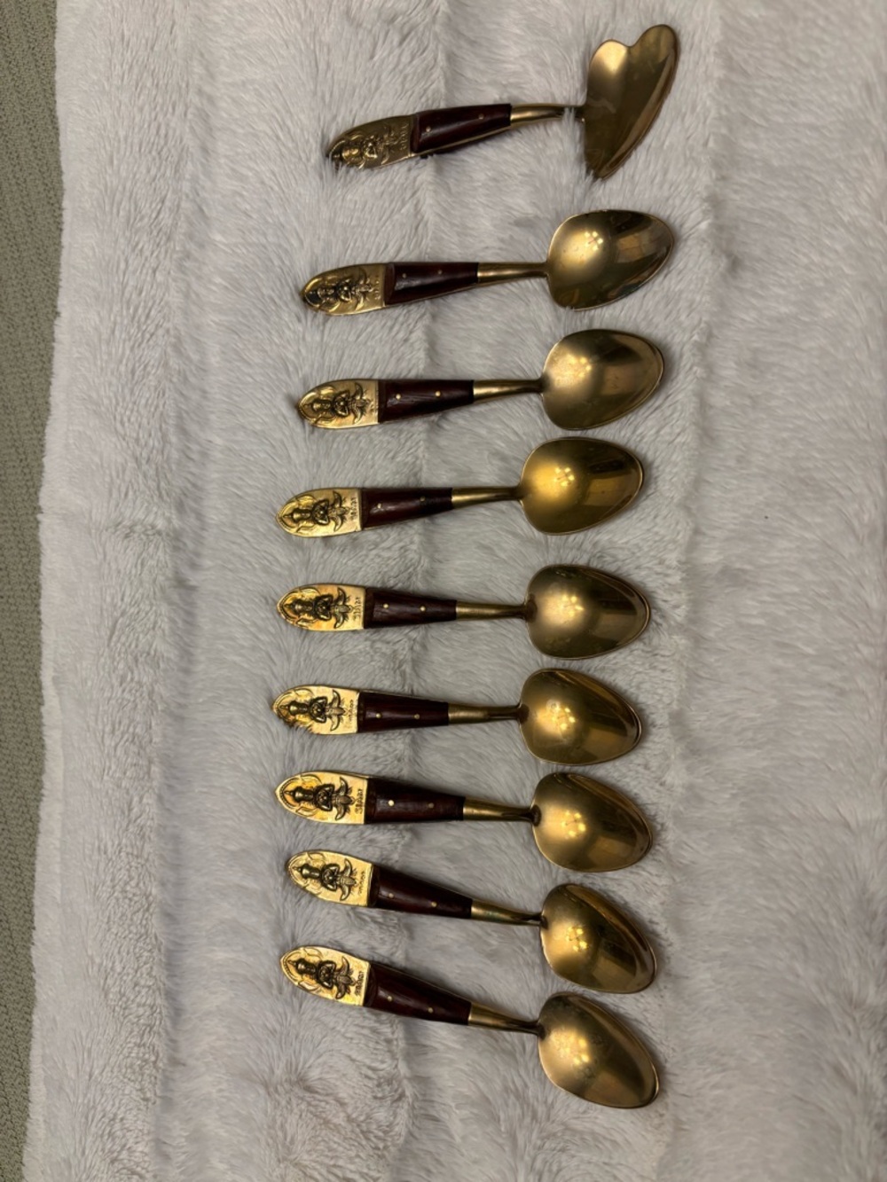 Set of eight vintage Siam Buddha brass and wood teaspoons and one jelly spoon